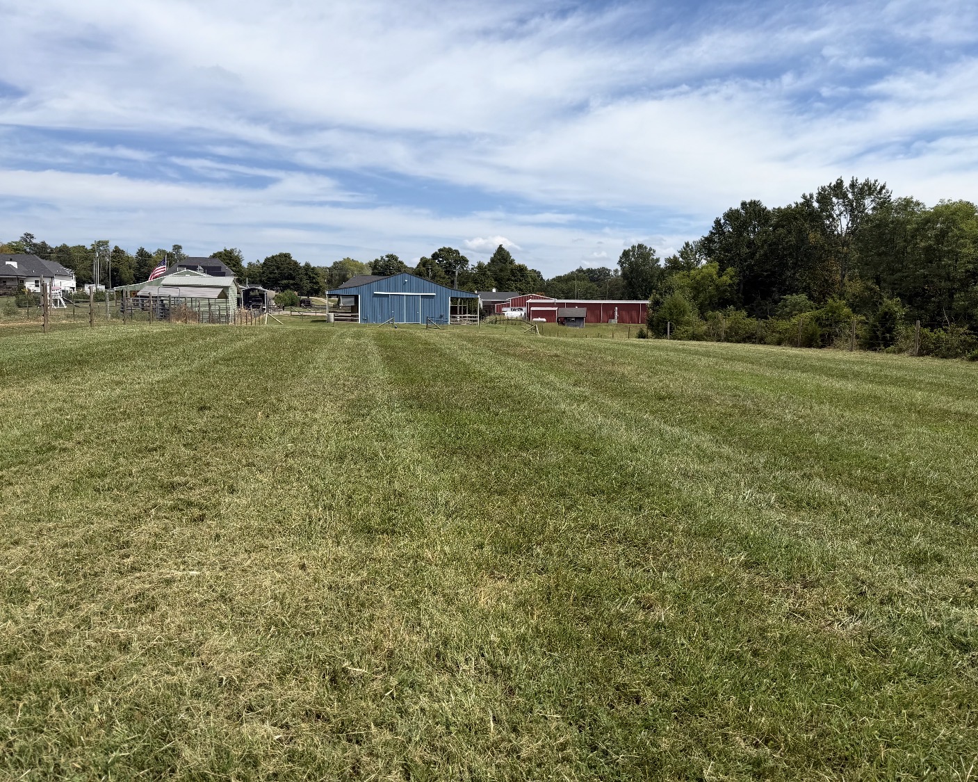 A freshly striped, mowed pasture under a clear sky