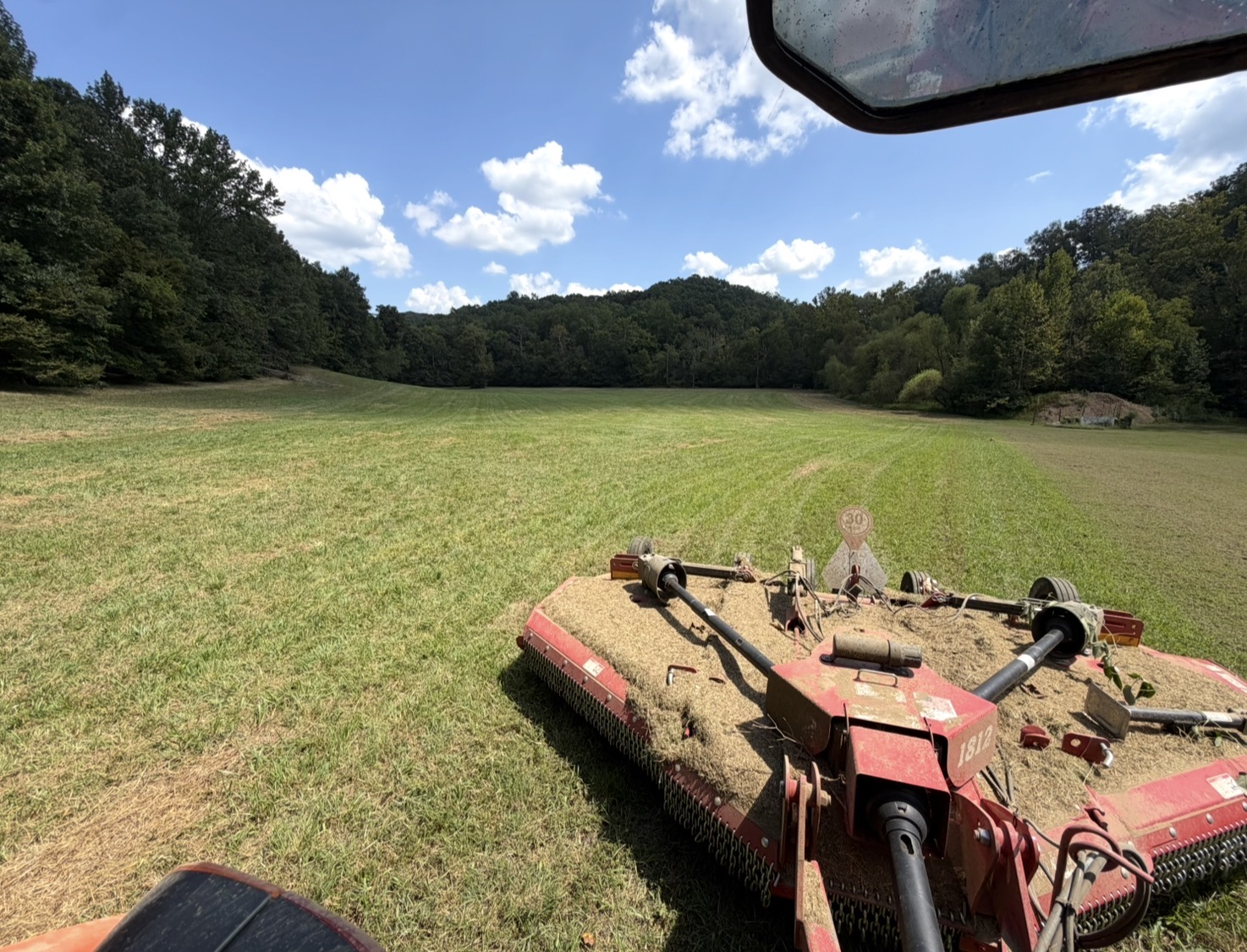 Brush hogging overgrown ground on a rural property